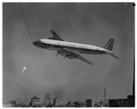 May 1963. Suspended model of Douglas DC-7B being photographed.
