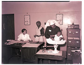Springs, 1940. Weighing baby in township clinic.
