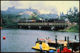 
SAR Class 19D steam locomotive with torpedo tender on viaduct.
