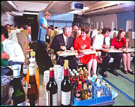 SAA Boeing 747 Interior. Food being served in first class. Hostess, steward, cabin crew.