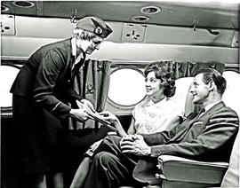 
SAA Douglas DC-4 Skycoach interior. Tea is served. Hostess.

