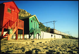 Cape Town. Muizenberg beach cabins with suburban train in the background.