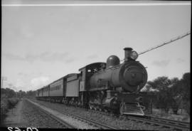 Cape Town district. SAR Class 8 with short passenger train in open country. Note first coach is e...