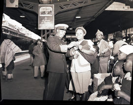 Johannesburg, October 1946. Black railway officer assisting passenger at Park station.
