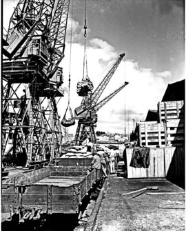 Port Elizabeth, 1948. Cranes loading bags from trains in Port Elizabeth harbour.