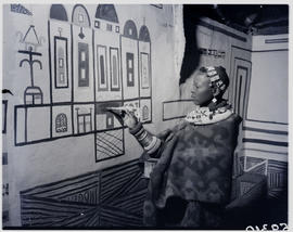Pretoria district, 1952. Ndebele woman painting on wall.
