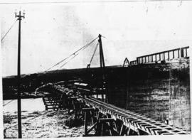 Humansdorp district, October 1910. Gamtoos River bridge: Hoisting 40 feet girders onto piers from...