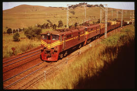 Natal. Goods train headed by SAR Class 5E1 Srs 2 No E597 with a train of mine props.