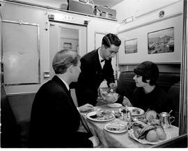 July 1965. Dinner served in train compartment.