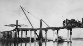Wilderness, circa 1926. Wilderness bridge construction: Getting ready to screw the first steel pi...