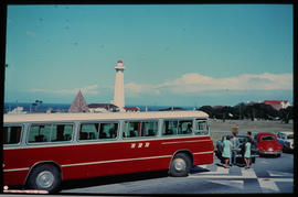 Port Elizabeth. SAR Mercedes Benz tour bus at the Donkin with lighthouse in the distance.