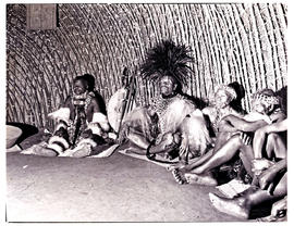 Natal, 1943. Zulu chief with elders inside hut.