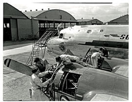 
SAA Douglas DC-4 undergoing maintenance outside.
