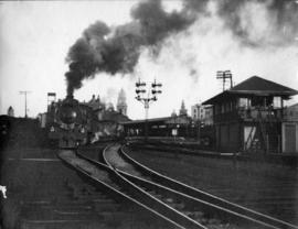 Durban, 1900. Train steaming past signal cabin.