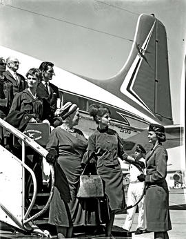 
SAA Douglas DC-7B ZS-DKG, hostess with passengers on stairs.
