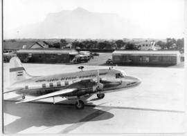 Cape Town. Wingfield Airport. SAA Vickers Viking ZS-BNL 'Mount Prospect'. Note Commer Commando bus.