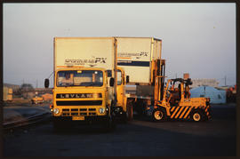 
SAR Leyland truck and forklift loading containers.
