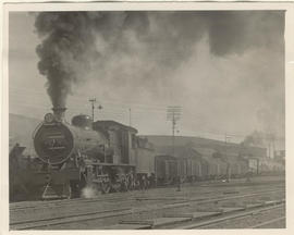 SAR Class 16C No 824 with goods train at station.