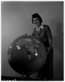 November 1957. Return of SAA Douglas DC-7B goodwill flight from Australia, SAA hostess posing at ...