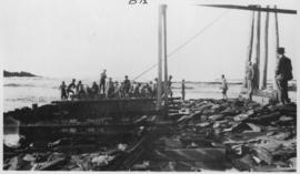 Wilderness, circa 1926. Kaaimans River bridge construction: Seating no 6 trestle on rock mat with...