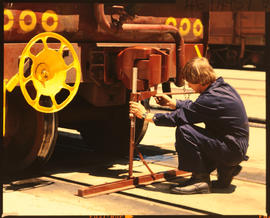 Bapsfontein, November 1986. Checking wagon coupling at Sentrarand. [T Robberts]