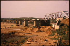 
Construction of long steel truss bridge on concrete piers.
