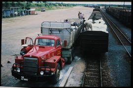 
SAR International Harvester truck No MT80062 loading bags onto goods train.
