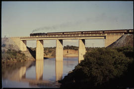 Virginia district. Orange Express passenger train on bridge over river.