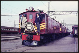 Two men standing next to the headboard 'Historic Transport Association - 150th Anniversary of Ste...