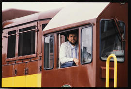 Driver in cab of a SAR Class 34-000 diesel locomotive.