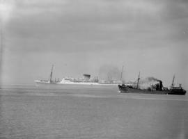 Cape Town, 1954. Union Castle Line steam ship and fishing boat in Table Bay harbour.