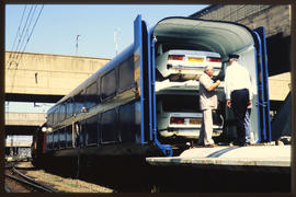 
Motor vehicles parked in Blue Train vehicle van. SAR type SCL=5 motor car carrier.
