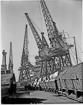 Port Elizabeth, 1948. Cranes loading paper rolls onto train in Port Elizabeth harbour.
