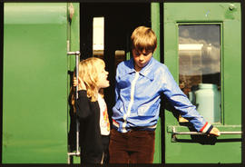 
Children in doorway of Apple Express passenger train.
