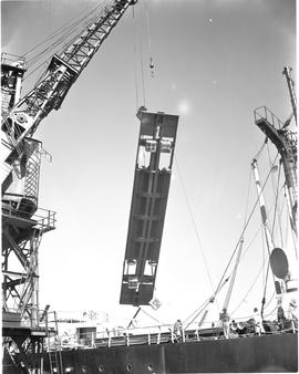 Port Elizabeth, 1948. Steel platform lifted by crane in Port Elizabeth harbour.