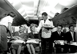 
SAA Douglas DC-7B interior. Coffee is served. Steward and Hostess.
