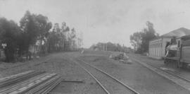Blaney, 1895. Entrance to station with Cape 7th Class on shed and stack of rails. (EH Short)