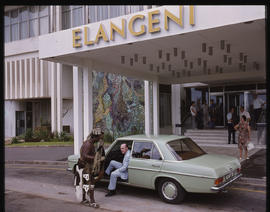 Durban. Guest stepping out of Mercedes Benz car at Elangeni Hotel.