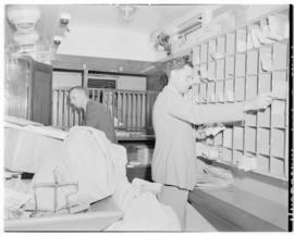 Rhodesia, April 1947. Staff sorting mail in the post office carriage of the Pilot Train.