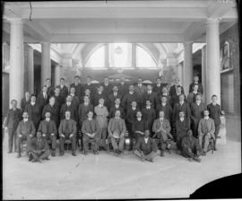 Group of men posing inside building