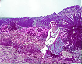 Woman posing garden amongst wildflowers.
