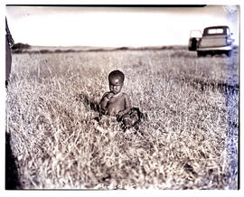 Natal, 1949. Zulu child sitting in grass.