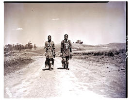 Zululand, 1950. Two Zulu men walking down road.