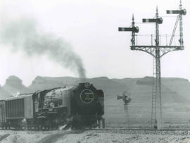 Beaufort West district, 1956. SAR Class 25 goods train at Three Sisters.