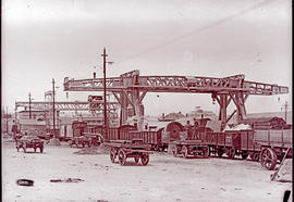 Johannesburg. Two large gantry cranes at Kazerne with mule carts and train wagons.