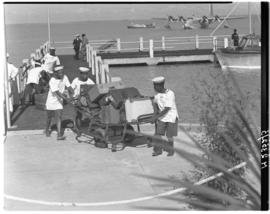Vaal Dam, May 1948. Arrival of BOAC Solent flying boat G-AHIN 'Southampton'. Porters hauling lugg...