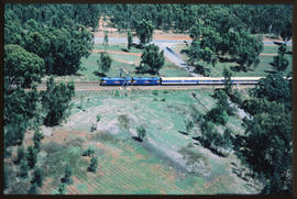 
Aerial view of Blue Train in forested area.
