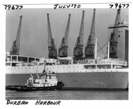 Durban, July 1970. Harbour tug 'Danie du Plessis' alongside the 'Windsor Castle' of the Union-Cas...