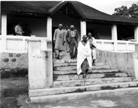 Tzaneen district, 1946. Queen Modjadji on stairs of farmhouse, elders following.