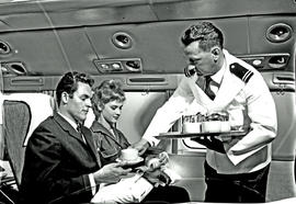 
SAA Douglas DC-7B interior. Coffee is served. Steward.
